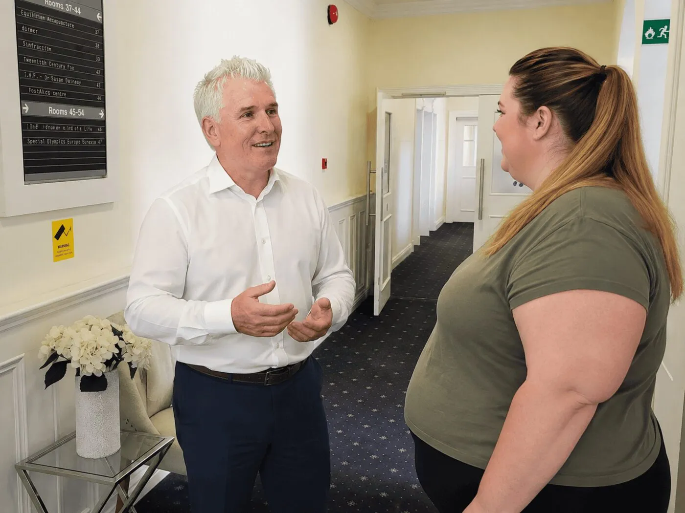 A consultant greeting a patient at the clinic