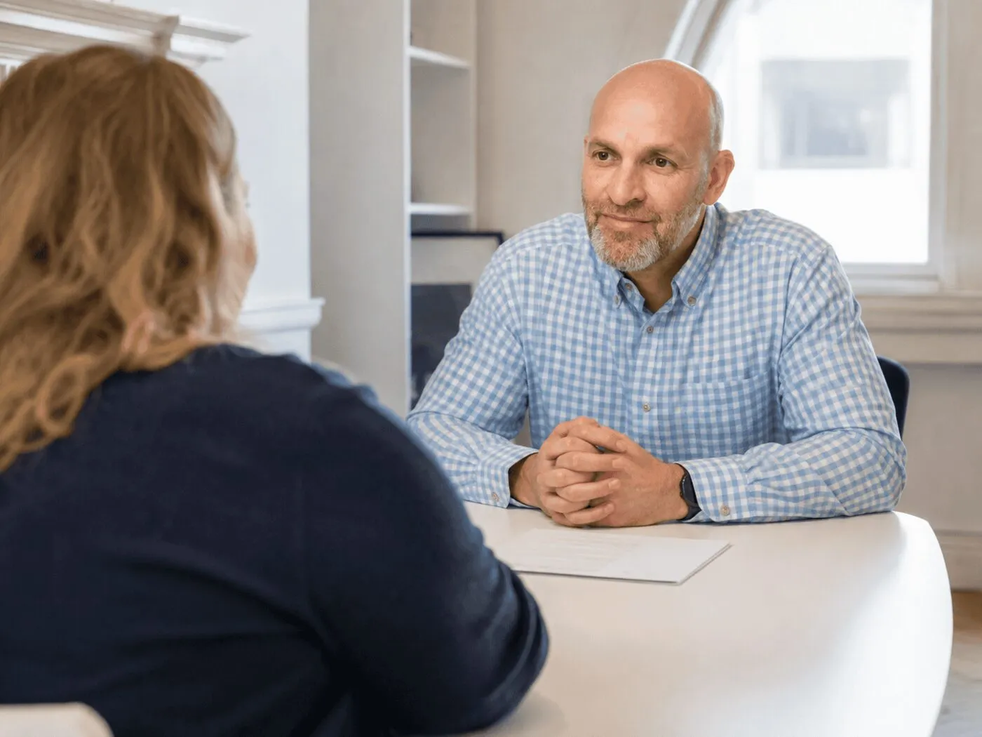 A consultant and patient in conversation across the table