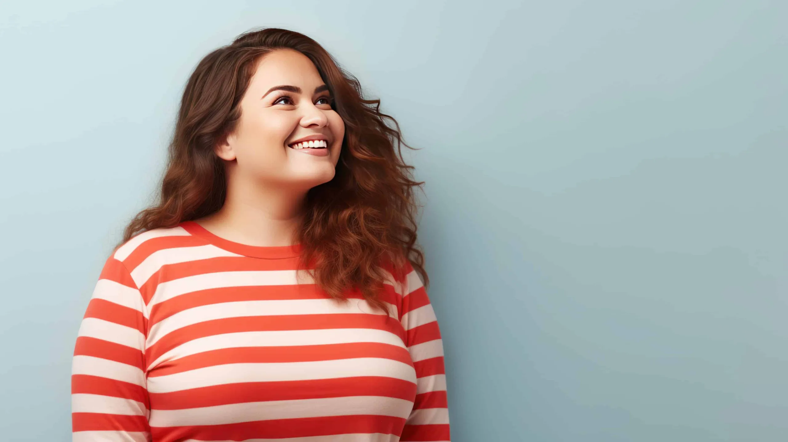 A woman smiling, looking away from camera